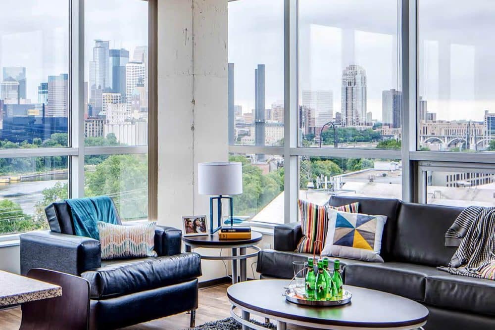 the bridges dinkytown off campus apartments near the university of minnesota fully furnished living room large windows overlooking minneapolis skyline